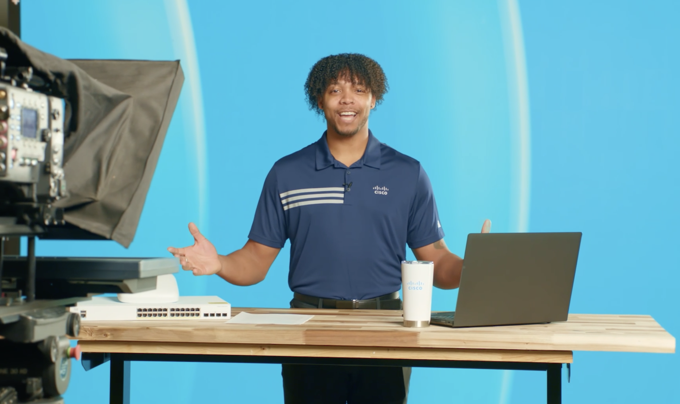 Young man standing behind the cisco desk